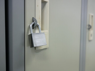 key hanging on locker in locker room.	