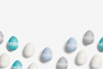 Easter eggs pastel colors green, blue, gray, beige on white background. Symbol Easter holiday, celebration food concept, dyed chicken egg trendy color and decorated lace tape. Top view