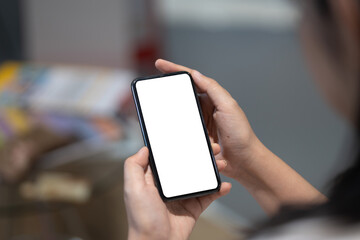 Top view woman sitting and holding blank screen mock up mobile phone