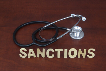 Stethoscope with word sanctions. Medicine and sanctions concept.