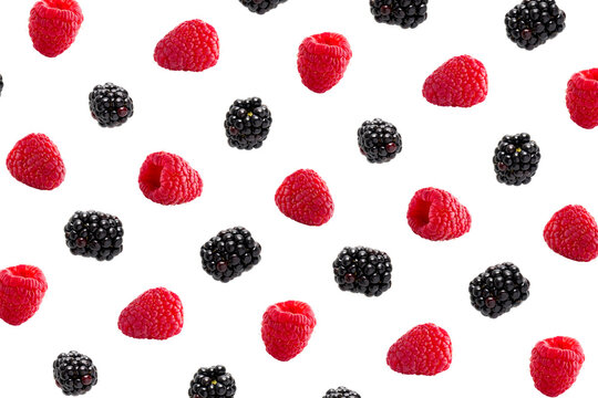 Raspberries abstract background. Fruit pattern of colorful wild berries isolated on white background. Raspberries, blackberry and brumble. Top view. Flat lay