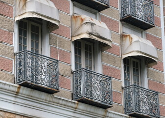 Building with wrought iron balconies and canopy awnings