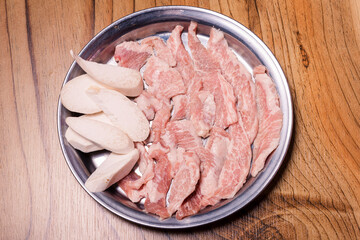 Raw pork on plate, Korean traditional style fresh pork beef belly BBQ, Japanese meat hot pot or Shabu in the restaurant, barbecue food