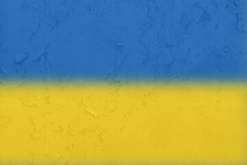 Ukrainian flag on a textured background. The flag of Ukraine on the old grunge wall in the background, the concept of destruction and war in Ukraine.Support for Ukrainians in the war with Russia
