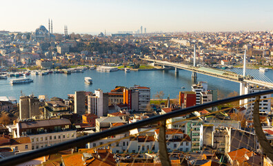 Fototapeta premium View from Galata Tower of Golden Horn bay with cable-stayed metro bridge connecting Beyoglu and Fatih districts, Suleymaniye Mosque in background, Istanbul, Turkey..