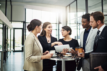I expect a lot more from you. Cropped shot of a group of businesspeople looking at a tablet in the office.