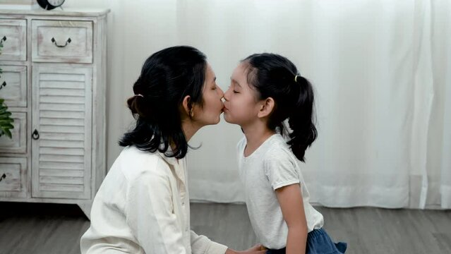 4K 25fps Slow Motion, An adorable Asian girl sits with a single mother, the little boy shows his love for her mother with a warm kiss on the cheek and a hug. Family and Healthy..