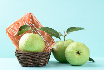 Fresh Guava fruit with leaf in basket on color background, Tropical high vitamin C fruit