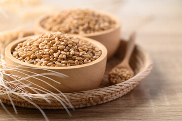 Whole wheat grain in wooden bowl, Food ingredients