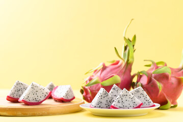 Fototapeta na wymiar Sliced dragon fruit or pitaya ready to eating on yellow background, Tropical fruit