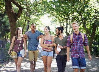 Happy classmates en route. Shot of college students hanging out on campus.