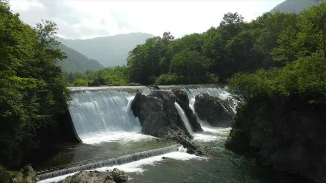waterfall in the forest taken with a drone shooting
