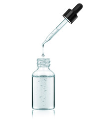Stretched drop drips from a pipette in bottle isolated on a white background
