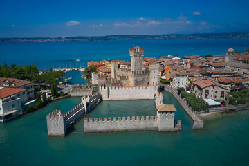 An ancient village on southern Garda Lake. Aerial view on Sirmione sul Garda. Italy, Lombardy. View by Drone. Rocca Scaligera Castle in Sirmione.