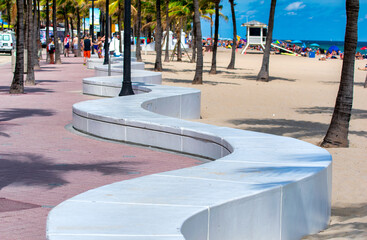 Seafront beach promenade with palm trees on a sunny day in Fort Lauderdale.