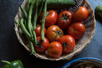 Farm fresh red tomatoes in a basket. Close up, selective focus.