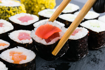 close-up, assorted classic Japanese salmon and tuna rolls with wooden sticks