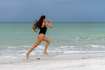 Fototapeta na wymiar Lovely Mixed Race Bikini Model Posing Outdoors On A Caribbean Beach