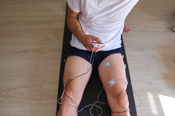 electrostimulation treatment, electrodes on a man's leg, tens treatment, ems or massages to improve muscle health and blood circulation. rehabilitation