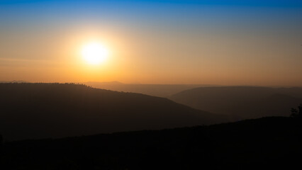 Mountains Alternate behind The Blue and Yellow Sky