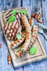 Home made Grilled sausages and Meatballs on wooden rustic background