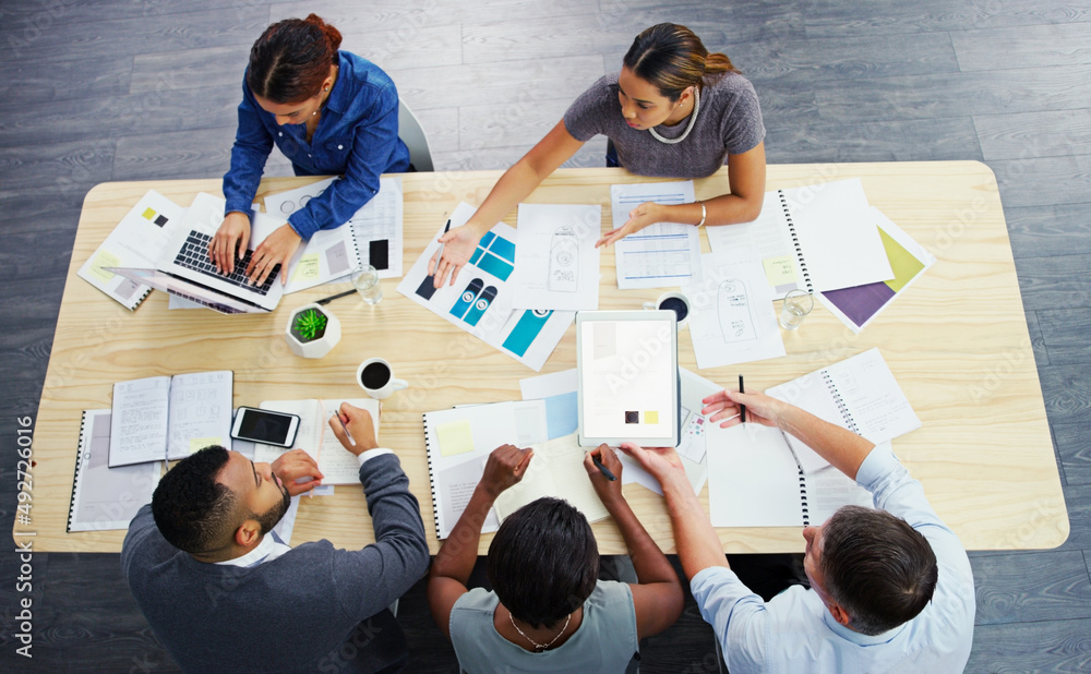Poster lets put it all on the table guys. high angle shot of a group of businesspeople having a meeting aro