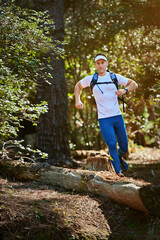 Enjoying nature on the run. Shot of a young man running along a nature trail.