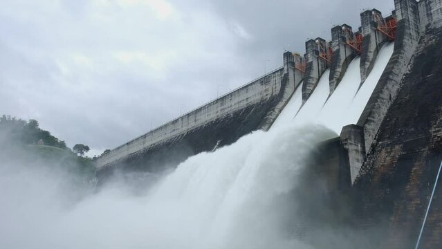 A large dam is draining because of heavy rain. The amount of water in the dam is too high.