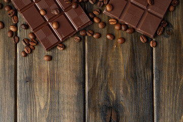 Roasted coffee beans with black chocolate close up