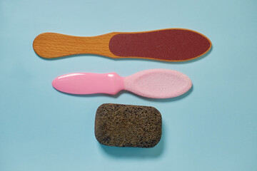 Pedicure accessories. Three types of graters for foot care on a blue background