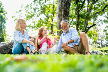 Fototapeta premium Happy family parent and child relax in weekend holiday lifestyle park outdoor nature background.
