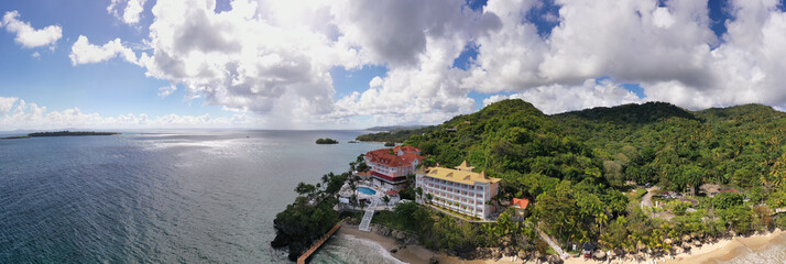 a tropical island with a snow-white beach and a house and a turquoise sea in the Dominican Republic taken from a drone