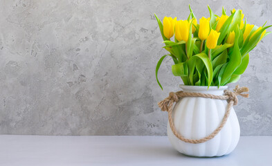 Bouquet of yellow tulips in a white vase