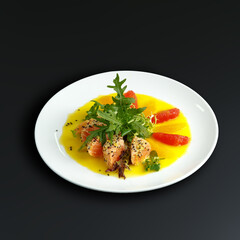 traditional dishes of European cuisine, delicacy, banquet snack. culinary dishes on a white plate on a black background. restaurant service