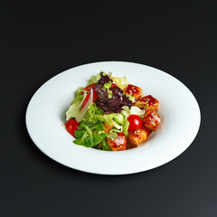 traditional dishes of European cuisine, delicacy, banquet snack. culinary dishes on a white plate on a black background. restaurant service