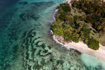 a tropical island with a snow-white beach and a turquoise sea in the Dominican Republic filmed from...