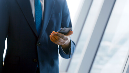 Businessman using a smartphone in the office. Business concept close up - 492732492