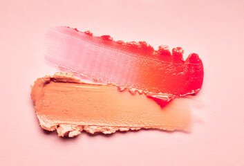 Lipstick burgundy peach orange brown balm lip gloss swatch isolated on beige background - obrazy, fototapety, plakaty