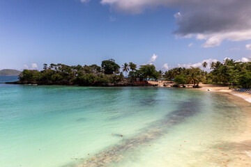 a tropical island with a snow-white beach and a turquoise sea in the Dominican Republic filmed from a drone 