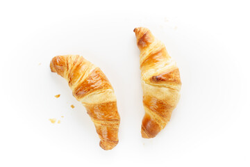 Flat lay home backed fresh French croissants isolated on white background