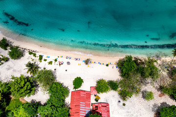 a tropical island with a snow-white beach and a turquoise sea in the Dominican Republic filmed from a drone 