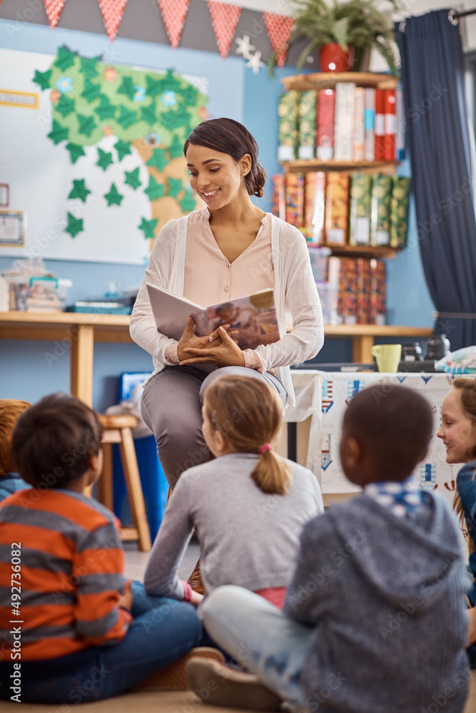 Aufkleber reading opens up their imaginations even further. shot of a teacher reading to a group of elementary