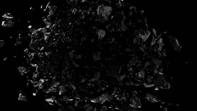 Super slow motion of rotating coal pieces on black background. Filmed on high speed cinema camera, 1000fps. Speed ramp effect.