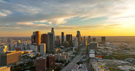 Naklejka na ściany i meble Los angeles aerial view, flying with drone. City of Los Angeles cityscape skyline scenic aerial view at sunset.