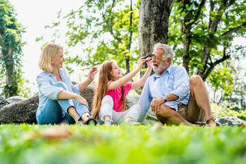 Fototapeta premium Happy family parent and child relax in weekend holiday lifestyle park outdoor nature background.