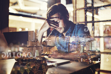 This day has been beyond stressful for me. Shot of a handsome young businessman suffering from a headache while working on his laptop at work.