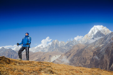 Fototapeta premium Active hiker hiking, enjoying the view, looking at Himalaya mountains landscape. Travel sport lifestyle concept