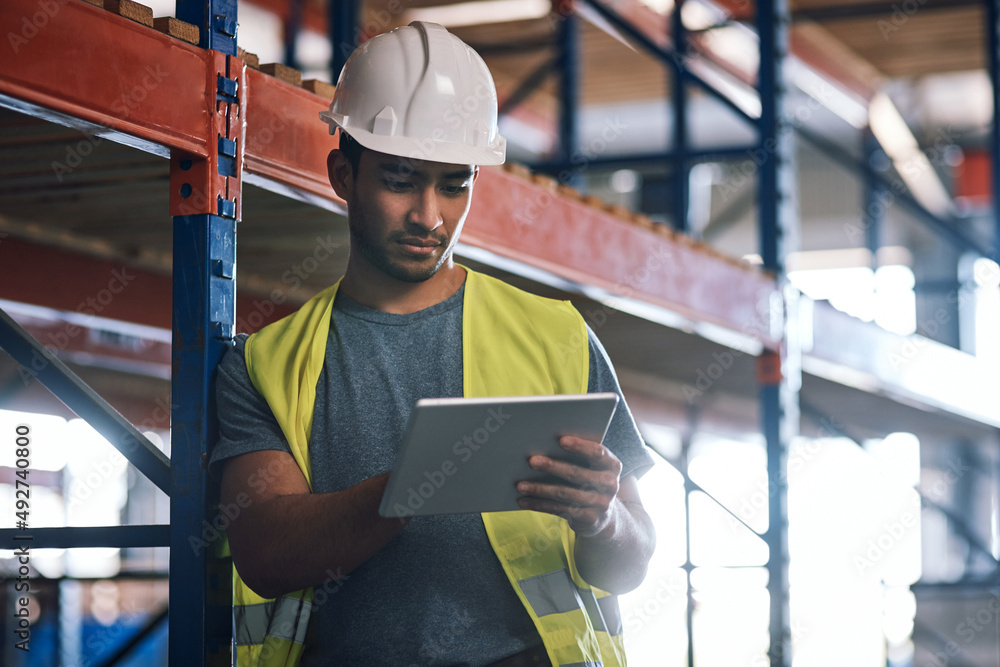 Sticker Get all the info where and when you need it. Shot of a builder using a digital tablet while working at a construction site.