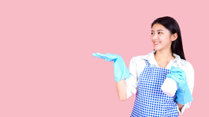 Portrait asian beautiful woman wearing apron and rubber gloves for cleaning , Housekeeper standing with products and equipment cleaner.