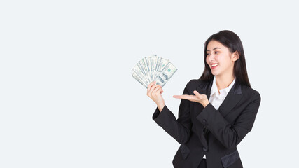 confident portrait beautiful asian woman successful wearing office clothing with US dollars money in hand feeling happy and smile, bankruptcy economic financial concept.